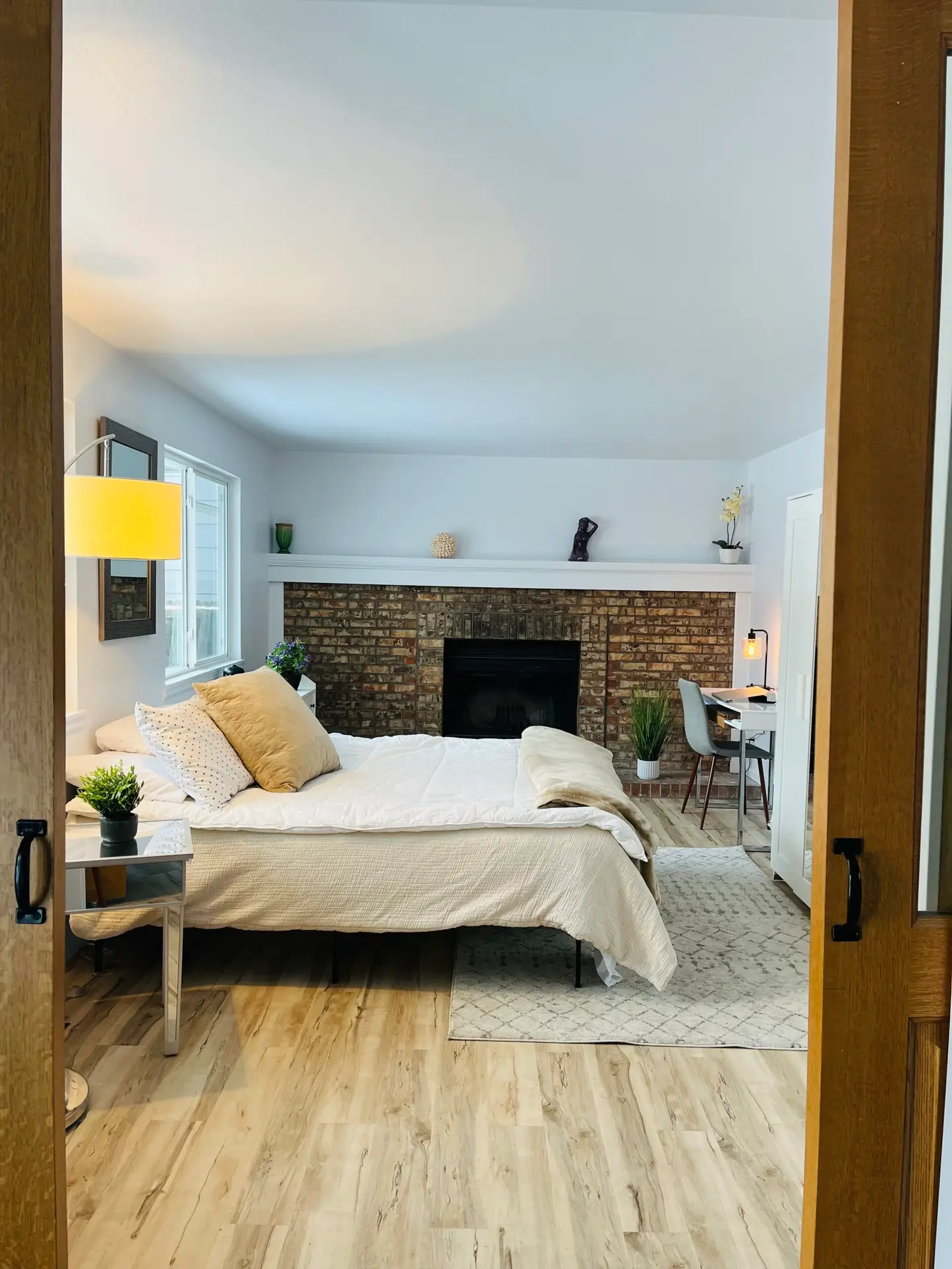 bedroom-with-brick-fireplace-and-desk-setup