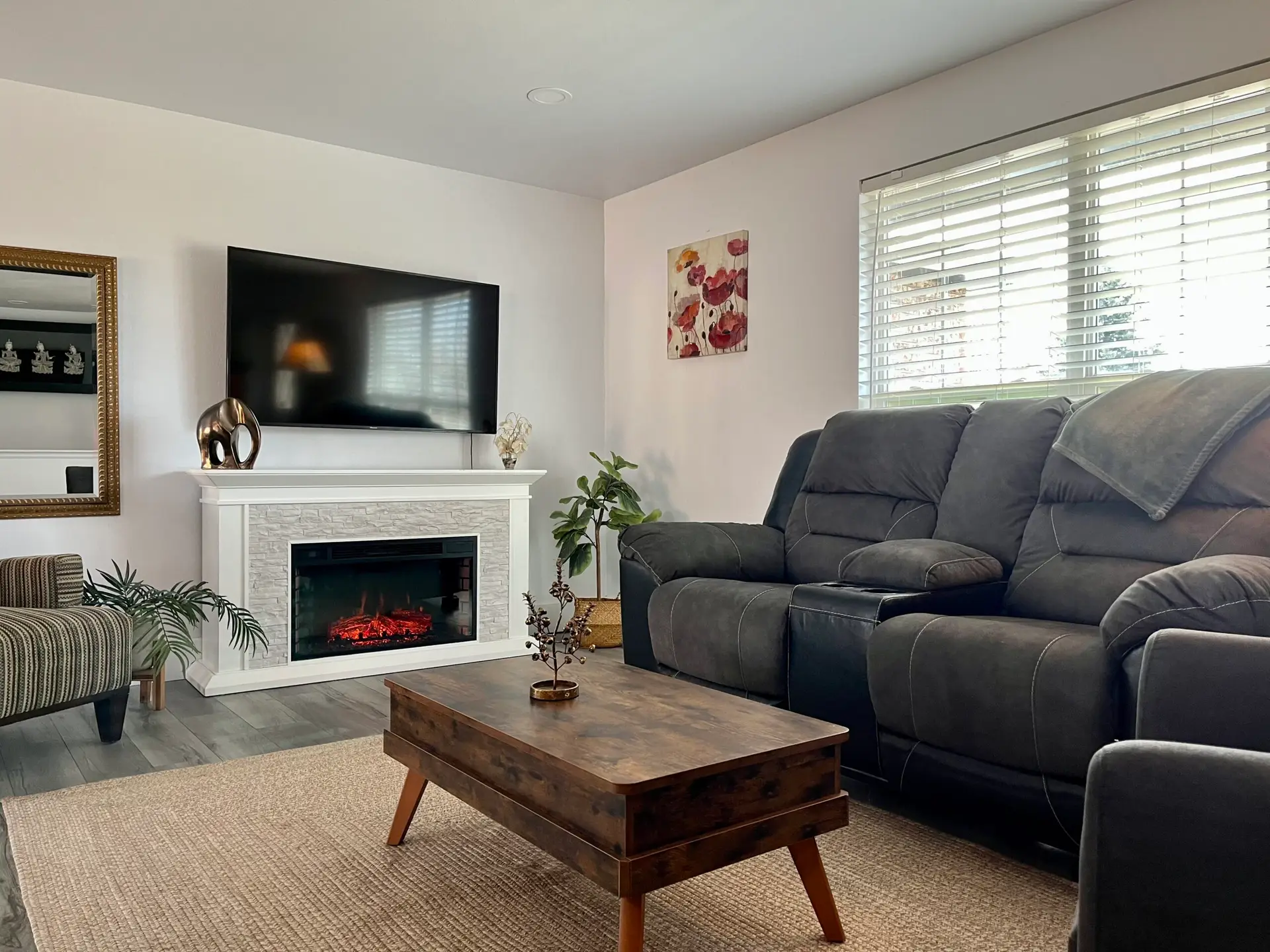 living-room-with-reclining-sofa-electric-fireplace-and-tv