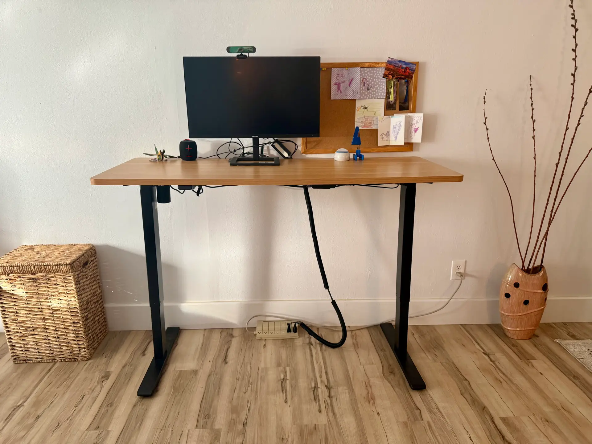 standing-desk-setup-with-monitor-and-corkboard